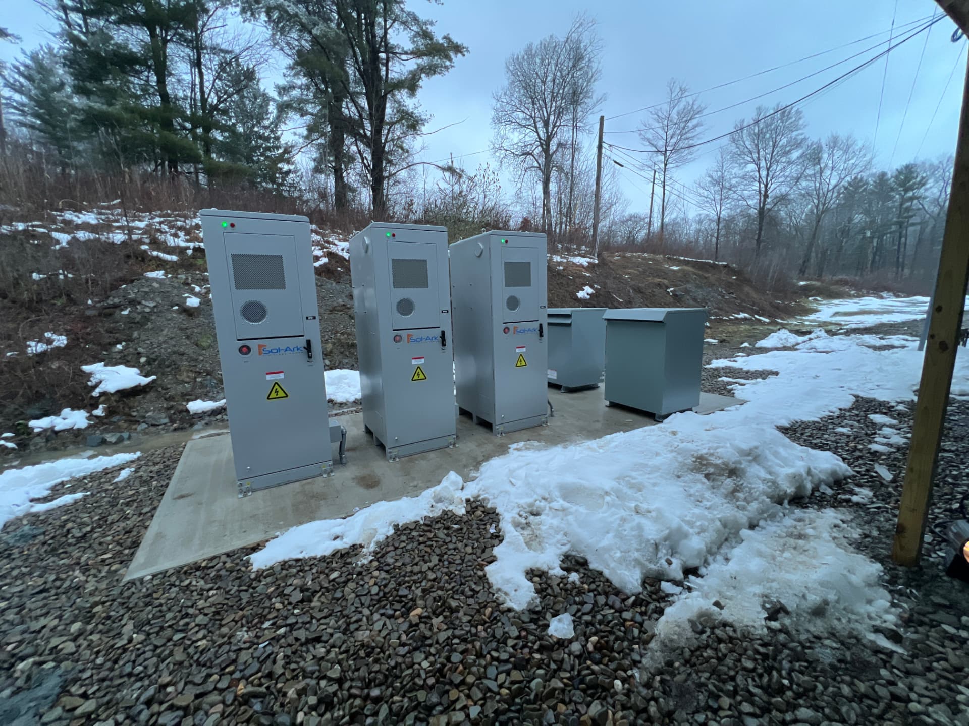 Commercial battery and inverter cabinets installed on a concrete equipment pad